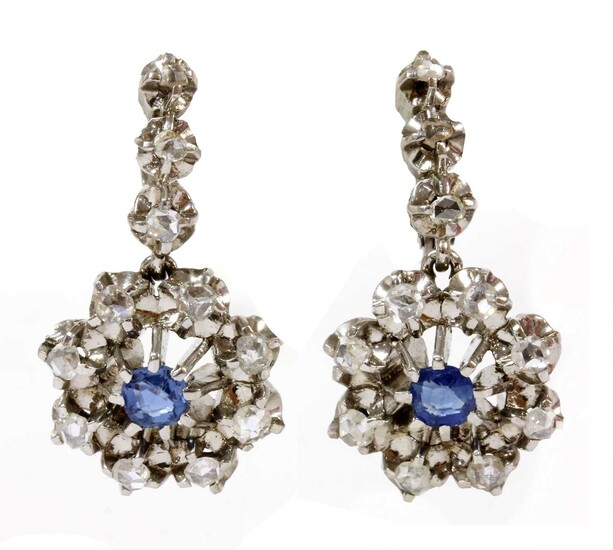 A pair of Continental platinum sapphire and diamond cluster earrings