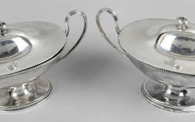 A pair of George III silver twin-handled sauce tureens.