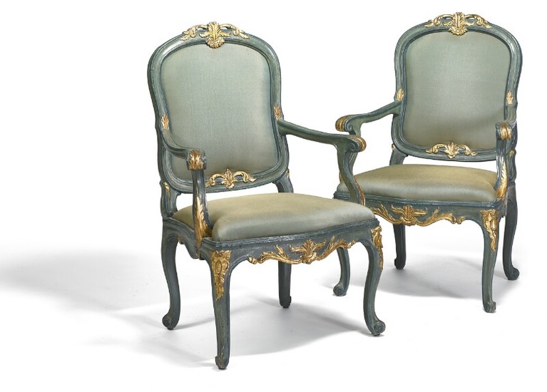 A pair of Venetian Rococo armchairs, green painted with giltwood carvings, loose drop-in seats and backs covered in green silk. Mid-18th century. (2)