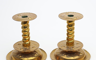 A pair of brass candlesticks, baroque style.
