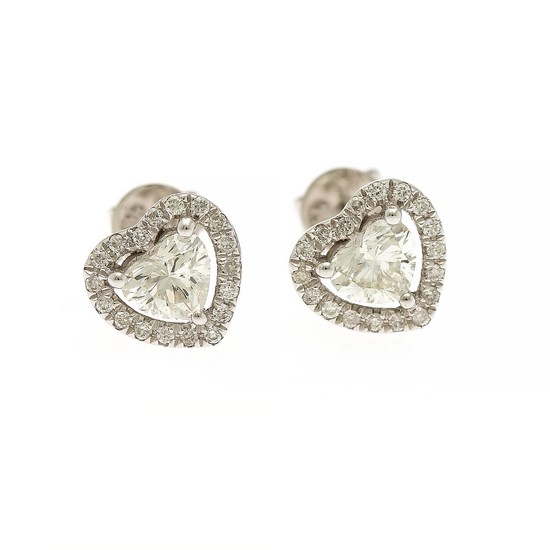 A pair of diamond ear studs each set with a heart shaped diamond encircled by numerous brilliant-cut diamonds, mounted in 18k white gold. (2)