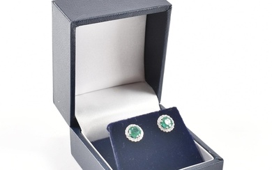 A pair of hallmarked 9ct white gold emerald and diamond stud...