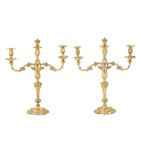 A pair of mid Victorian gilt copper three light candelabra