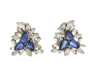 A pair of sapphire and diamond ear clips each set with three pear shaped sapphires and numerous diamonds, mounted in 18k white gold. (2)