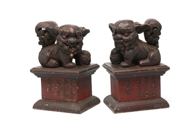 A pair of wooden figure of lions carved with Chinese and Thai characters