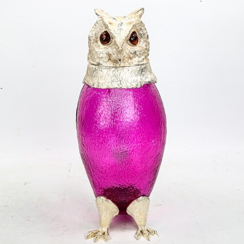 A purple glass and silver plate owl design Claret jug, with ...