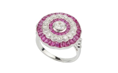A ruby and diamond cocktail ring, of target design, centred...