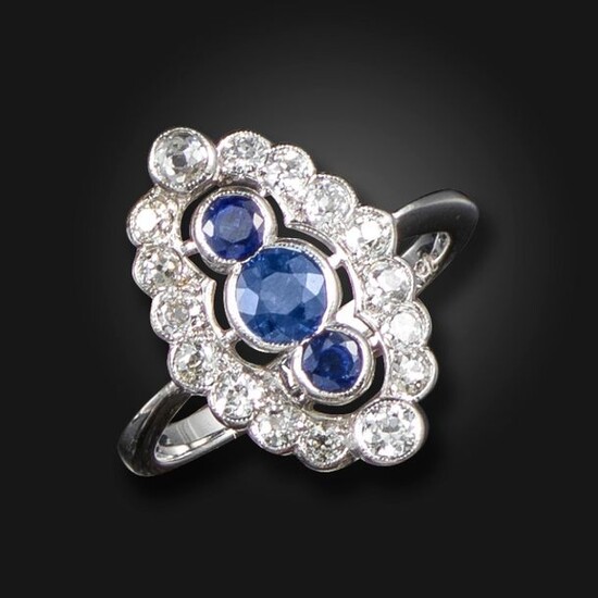 A sapphire and diamond cluster ring, set with three graduated...