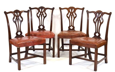 A set of four mahogany Hepplewhite-style dining chairs with leather...