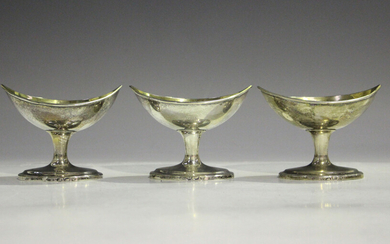 A set of three George III Irish silver salts, each of elliptical form with gilt interior, raised on