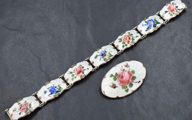 A silver guilloche enamel floral oval brooch depicting a rose, sold along with a matching