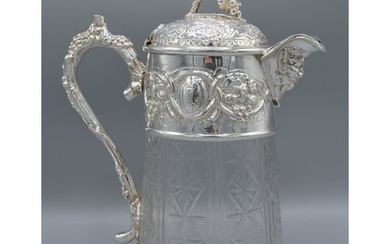 A silver plated and cut glass claret jug decorated with grap...