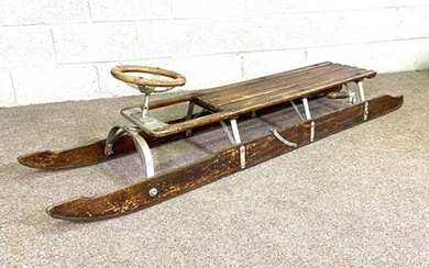 A vintage bobsled (or steerable toboggan), circa 1930, the long two person ash and iron sledge