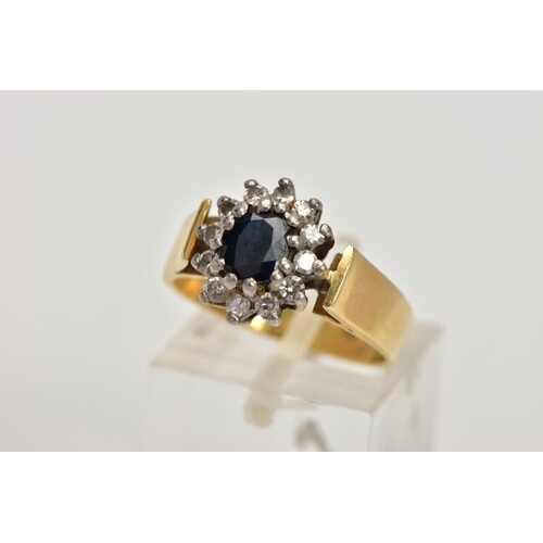 AN 18CT GOLD DIAMOND AND SAPPHIRE CLUSTER RING, centring on ...