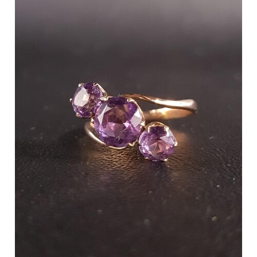 ATTRACTIVE AMETHYST THREE STONE RING in twist setting, the c...