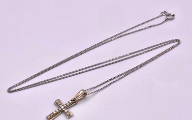 An 18KT White Gold, Double Crucifix Pendant on a...