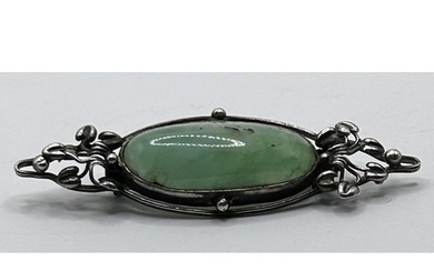 An Arts and Crafts silver coloured metal and green stone bro...