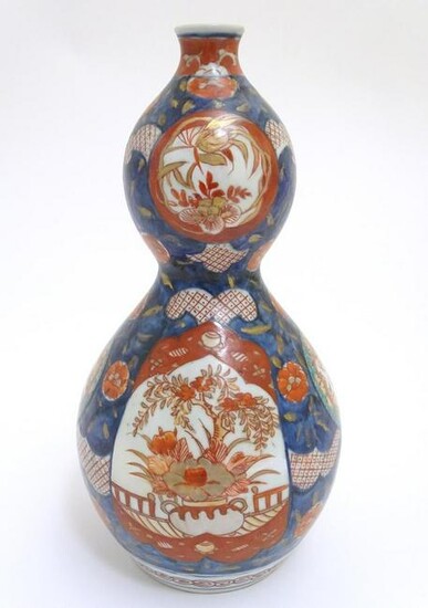 An Oriental double gourd vase in the Imari palette with