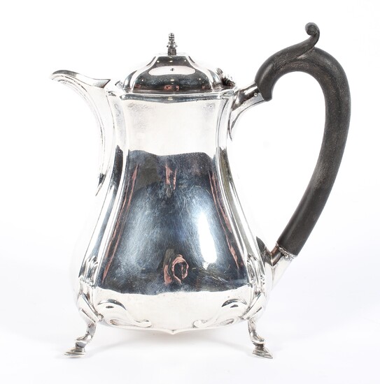 An early 20th century silver lidded hot water jug of waisted form