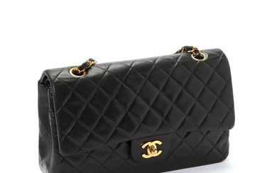 Chanel: A “Classic Double Flap” bag made of black quilted calf leather, gold toned hardware and double chain strap.