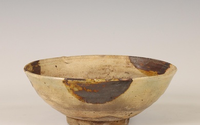 China, a cream-glazed pottery bowl, probably Tang dynasty (618-907)