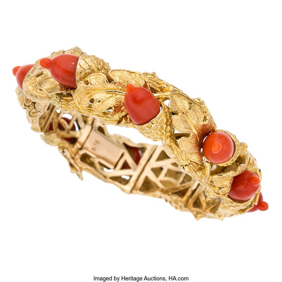 Coral, Gold Bracelet The bracelet features carved coral, set...