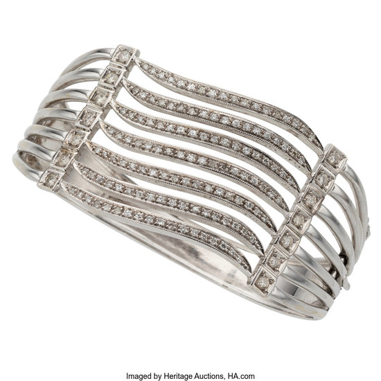Diamond, White Gold Bracelet The hinged bangle features full...