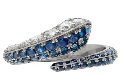 Diamond and blue sapphire crossover ring in white gold.