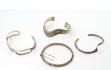 Four assorted silver bracelets / bangles, to include one wit...