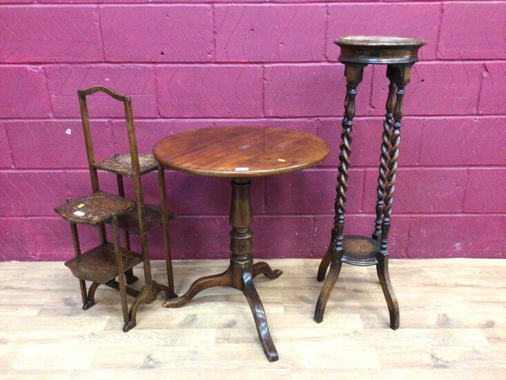 Georgian mahogany tilt top wine table, oak two tier torchere with spiral twist supports and an oak folding cake stand