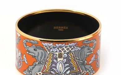 Hermès A “Medium Torana” bangle of gold coloured metal and orange enamel...