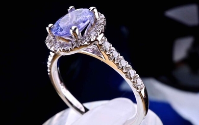 Jewelry. Unique piece. Superb ring in 18 kt white gold set with a certified oval cut Tanzanite of 0.92 ct and its entourage and ring body set with brilliant-cut natural diamonds for a total of 0.35 carat. Size (modifiable) 52, the ring is engraved and...