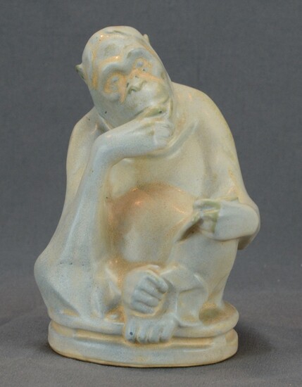Reading monkey sitting cross-legged on a round base, light grey glaze, design by Max Lange c. 1900