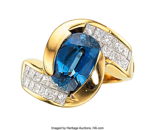 Sapphire, Diamond, Gold Ring The ring features an oval-shaped...