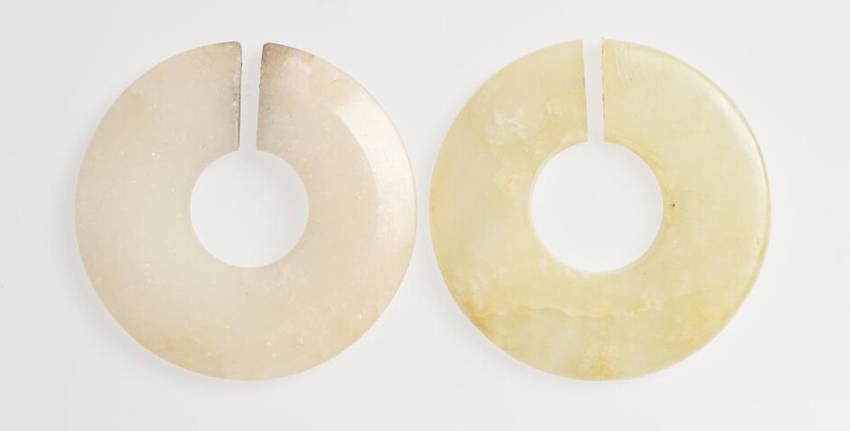 TWO CHINESE NEPHRITE JADE 'JUE' SLIT-RINGS EASTERN ZHOU (770-256 BC) OR HAN DYNASTY (202 BC-220 AD)