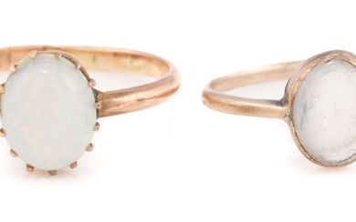 TWO VINTAGE 9CT GOLD STONE SET RINGS; set with an oval cabochon white opal with good play of colour (wear/ scratches) other with an...