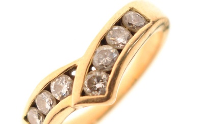 Unmarked yellow metal seven-stone diamond ring