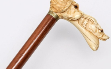 AN ANTIQUE SQUARED CROOK CANE WITH CARVED DOG