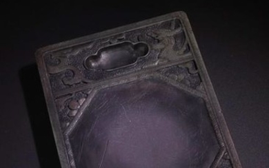 A PURPLE STONE INK SLAB WITH DRAGON CARVED