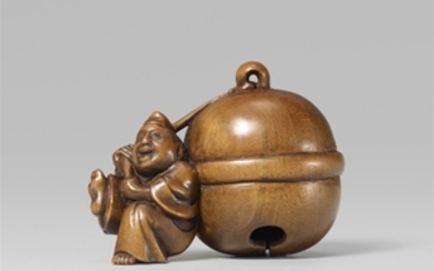 A boxwood netsuke of a laughing shrine attendant with a huge bell. Early 19th century