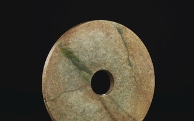 A LARGE GREEN, GREY AND RUSSET JADE DISC, BI, NORTHERN OR SOUTHWEST CHINA, 2ND MILLENNIUM BC