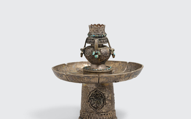 A turquoise-inset silver alloy altar piece