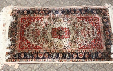 A 20TH CENTURY PERSIAN PART SILK RUG, beige ground with