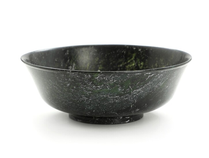 A 20th centurty Chinese dark green jade bowl. Weight app. 404 gr. H. 7. diam. 19 cm.