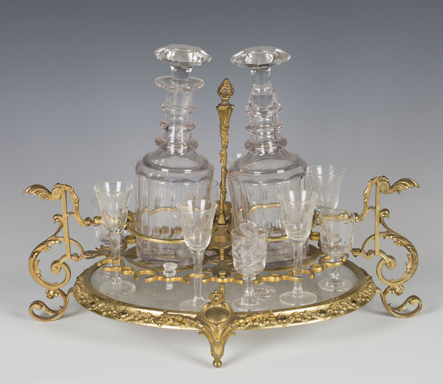 A 20th century French ormolu and cut glass liquor stand of oval form, fitted with two decanters and