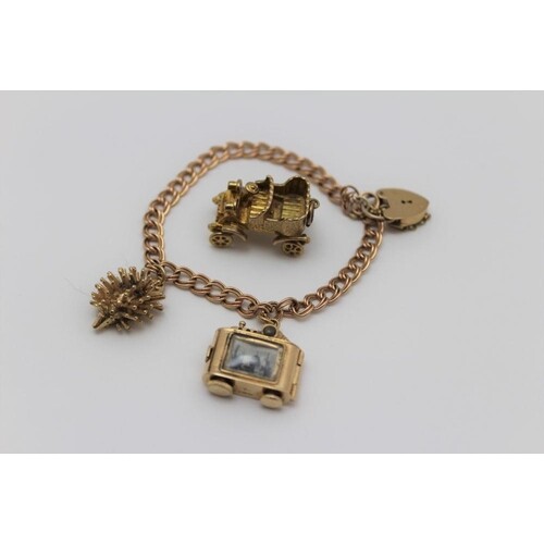 A 9ct gold charm bracelet with padlock clasp, a 9ct gold hed...