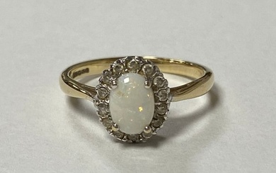 A 9ct gold dress ring, set with an oval opal and diamond clu...