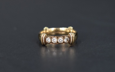 A 9ct gold wedding band having reided bands at four quarters and a four diamond inset, total