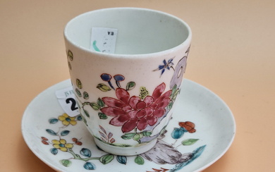 A BOW PORCELAIN COFFEE CUP AND SAUCER PAINTED WITH FLOWERS GROWING BY ROCKS