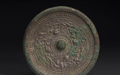 A CHINESE ARCHAIC BRONZE 'MYTHICAL BEAST' MIRROR
